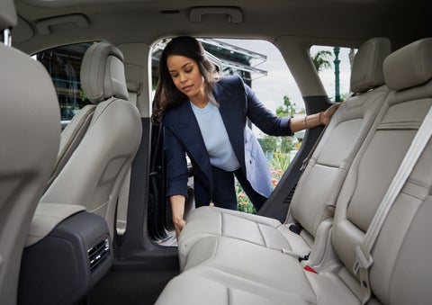 A woman slides the second-row seat forward to create more cargo space | Beck Lincoln in Palatka FL