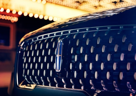 The Corsair Grand Touring grille shows floating chrome ovals that catch the glowing light of a theater marquee and frame the distinctive Lincoln Star | Beck Lincoln in Palatka FL
