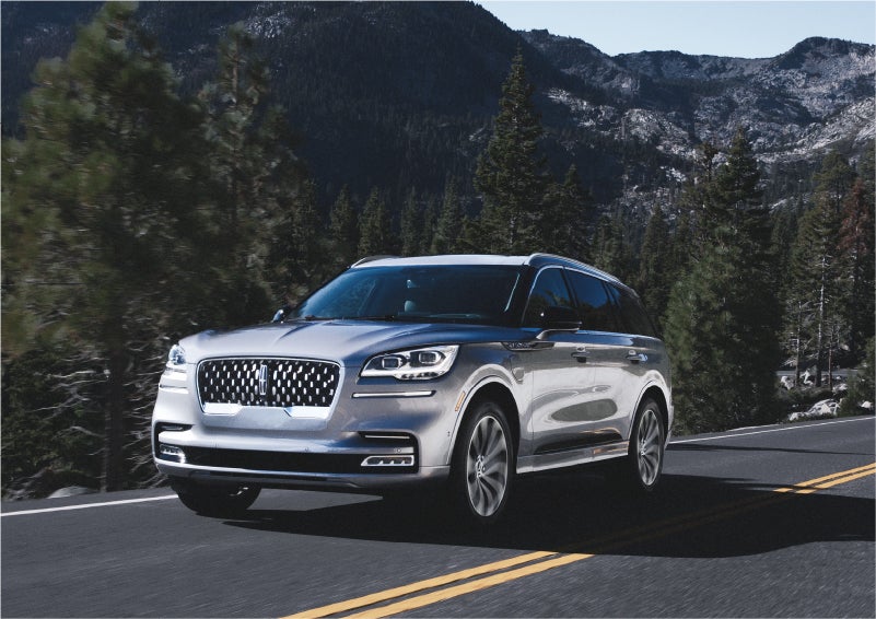 A 2023 Lincoln Aviator® Grand Touring SUV being driven on a winding road to demonstrate the capabilities of all-wheel drive | Beck Lincoln in Palatka FL