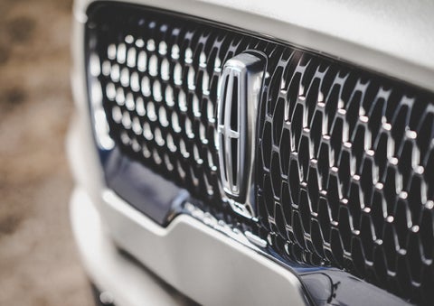The grille of the 2024 Lincoln Aviator® Reserve model with an eye-catching repeated field of Lincoln Star logo shapes | Beck Lincoln in Palatka FL