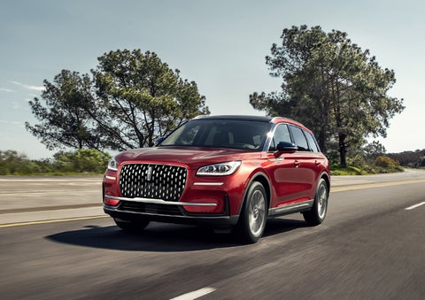 A 2024 Lincoln Corsair® SUV is shown being driven on a country road. | Beck Lincoln in Palatka FL